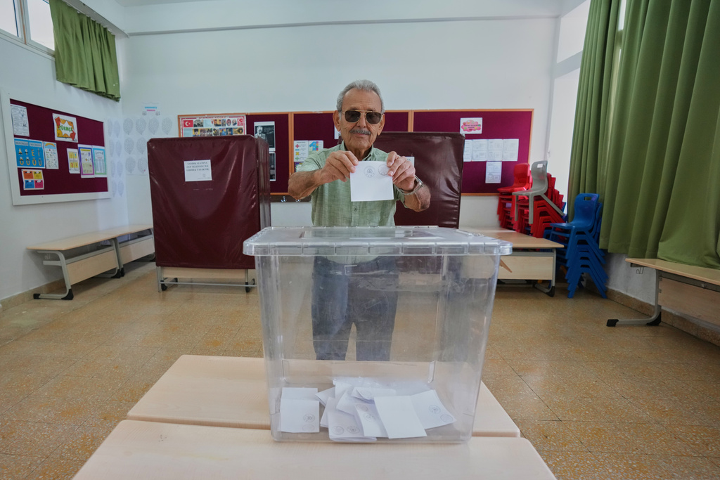 A man casts his ballot at a polling station during the Turkish Cypriot leadership election in the Turkish-occupied northern part of the divided capital Nicosia, Cyprus, Sunday, Oct. 19, 2025. (AP Photo/Petros Karadjias)