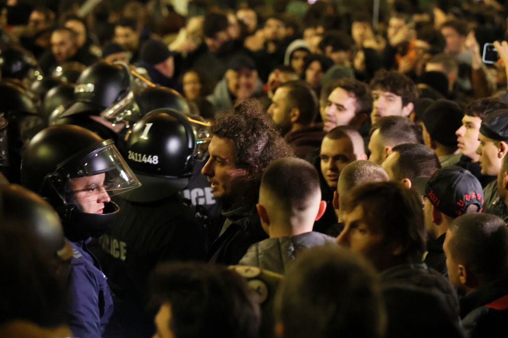 Protesters scuffle with police as thousands took to the streets of Bulgaria's capital, Sofia, to denounce steep tax hikes in next year's draft budget before being finally voted on in parliament, Wednesday, Nov 26, 2025. (AP Photo/Valentina Petrova)