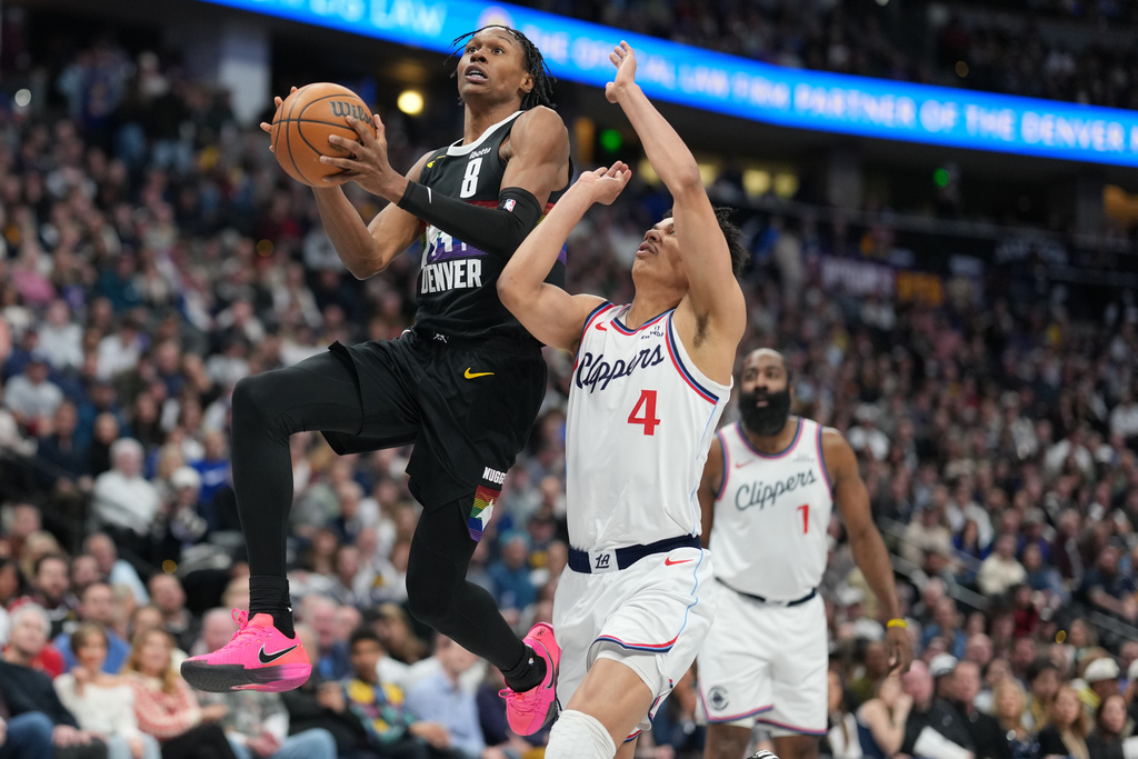 Denver Nuggets guard Peyton Watson, left, drives to the basket as Los Angeles Clippers guard Kobe Sanders (4) defends in the first half of an NBA basketball game Friday, Jan. 30, 2026, in Denver. (AP Photo/David Zalubowski)