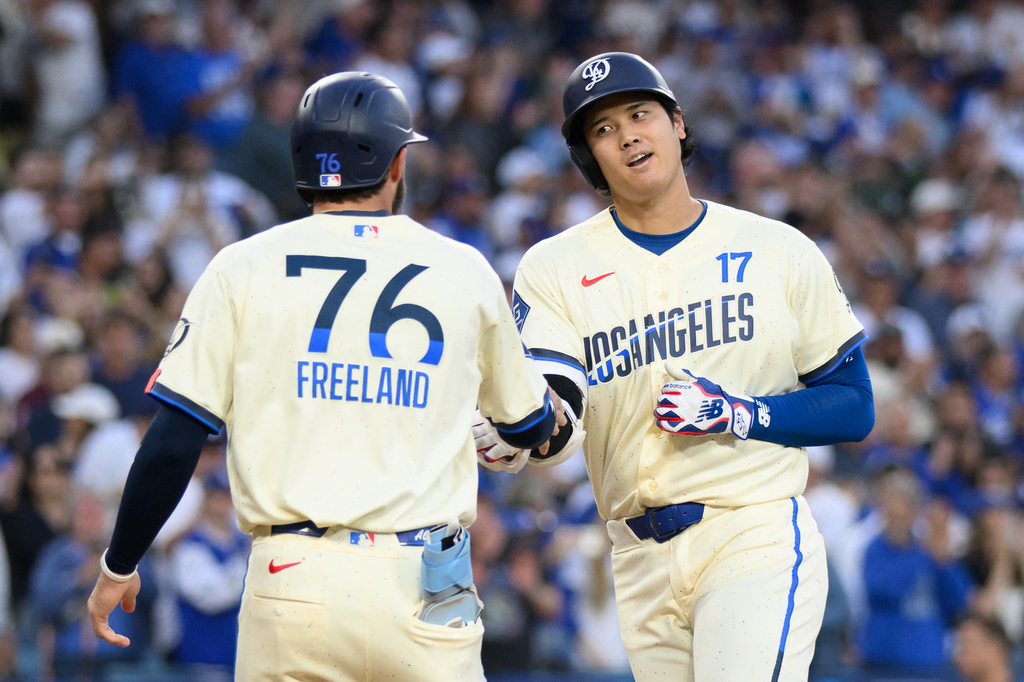 Los Angeles Dodgers' Shohei Ohtani, right, celebrates his two-run home run with Alex Freeland during the first inning of a baseball game against the Los Angeles Angels in Los Angeles, Saturday, June 6, 2026. (AP Photo/Kyusung Gong)