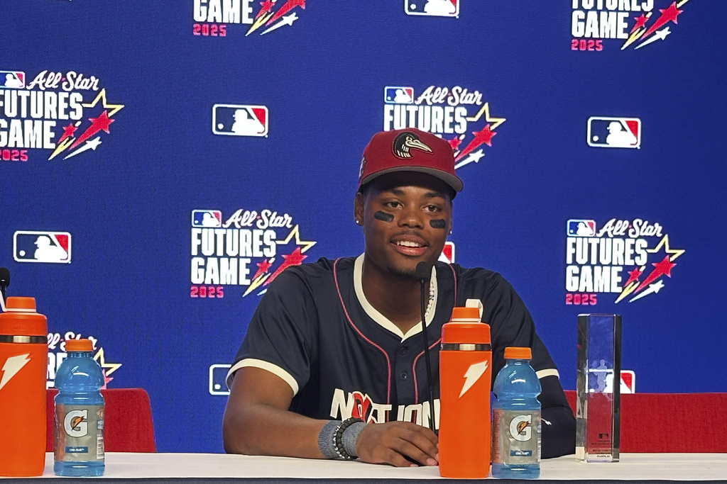 Los Angeles Dodgers prospect Josue De Paula speaks during a news conference at Truist Park, Saturday, July, 12, 2025 in Atlanta. (AP Photo/Charles Odum)