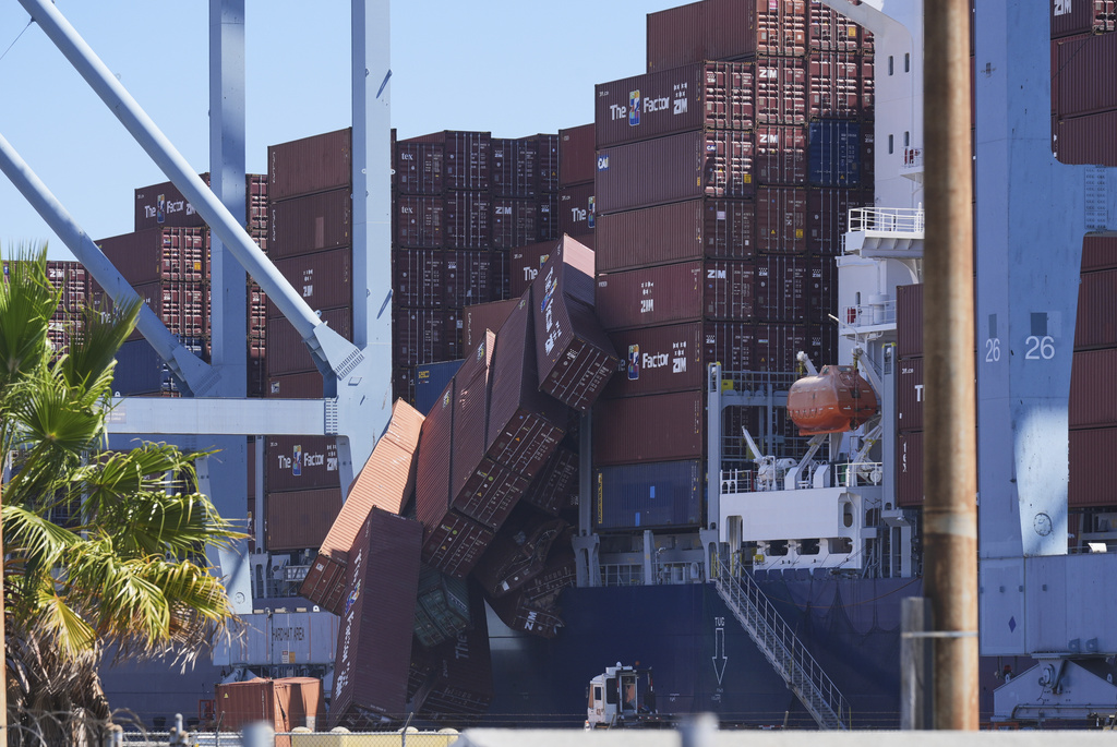 Containers topple off a cargo ship at the Port of Long Beach on Tuesday, Sept. 9, 2025, in Long Beach, Calif. (AP Photo/Damian Dovarganes)