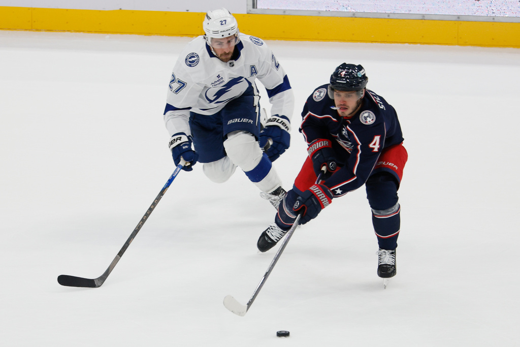 Columbus Blue Jackets' Cole Sillinger, right, looks for an open pass as Tampa Bay Lightning's Ryan McDonagh defends during the second period of an NHL hockey game Saturday, Oct. 18, 2025, in Columbus, Ohio. (AP Photo/Jay LaPrete)