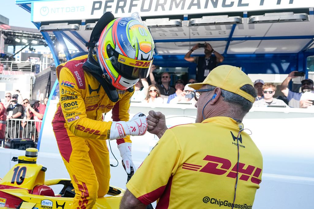 Alex Palou, of Spain, celebrates with a member of his crew during qualifications for the Indianapolis 500 auto race at the in Indianapolis, Sunday, May 17, 2026. (AP Photo/Michael Conroy)
