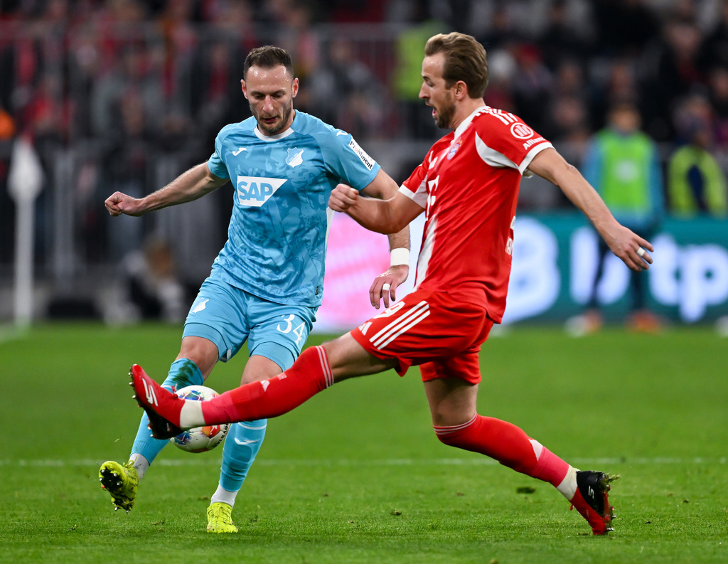 Bayern Munich's Harry Kane, right, and Hoffenheim's Vladimir Coufal in action during the Bundesliga soccer match between Bayern Munich and TSG 1899 Hoffenheim in Munich, Germany, Sunday Feb. 8, 2026. (Sven Hoppe/dpa via AP)
