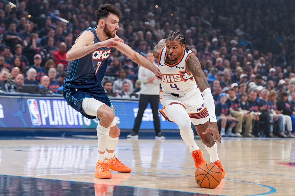 Phoenix Suns guard Jalen Green (4) drives past Oklahoma City Thunder center Chet Holmgren (7) during the first half in Game 2 of a first-round NBA playoffs basketball series Wednesday, April 22, 2026, in Oklahoma City. (AP Photo/Kyle Phillips)