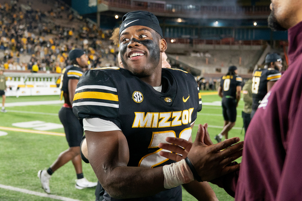 Missouri running back Ahmad Hardy, left, is congratulated after his team defeated Mississippi State in an NCAA college football game Nov. 15, 2025, in Columbia, Mo. (AP Photo/L.G. Patterson)