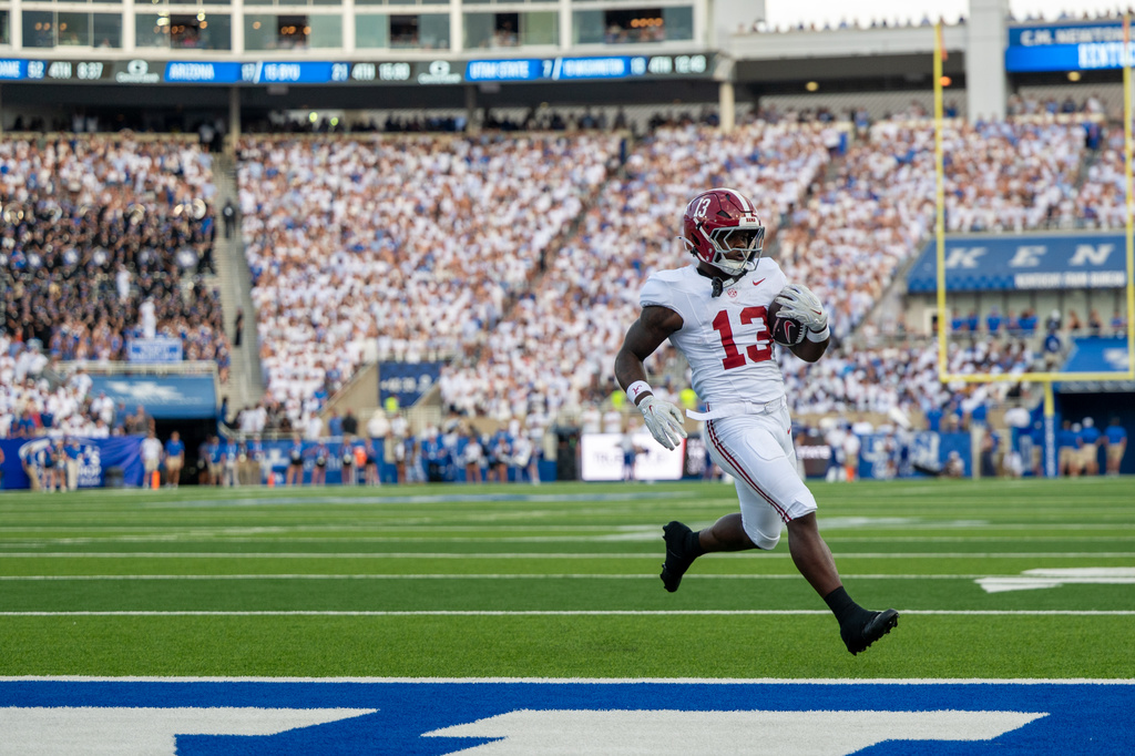Alabama running back EJ Crowell (13) scores a touchdown during the second half of an NCAA college football game against Kentucky, Saturday, Sept. 12, 2026, in Lexington, Ky. (AP Photo/Tony Wagner)