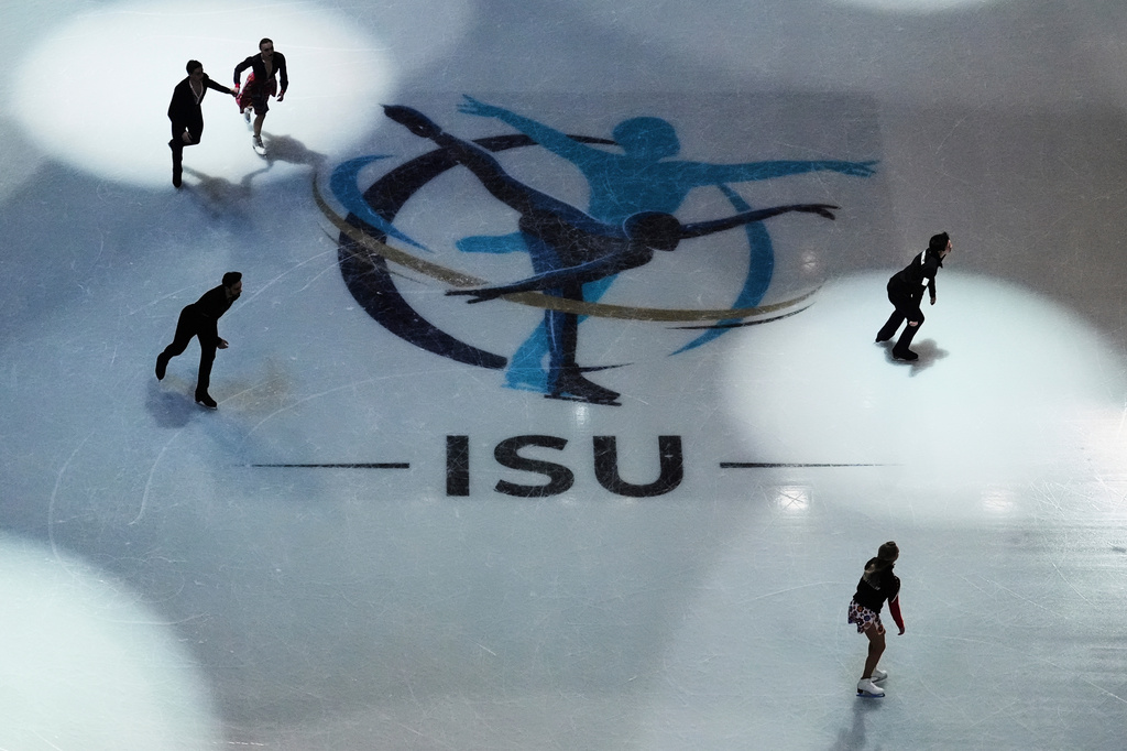 FILE - Skaters warm up before performing during the ice dance rhythm dance program at the figure skating world championships, Friday, March 28, 2025, in Boston. (AP Photo/Charles Krupa, File)