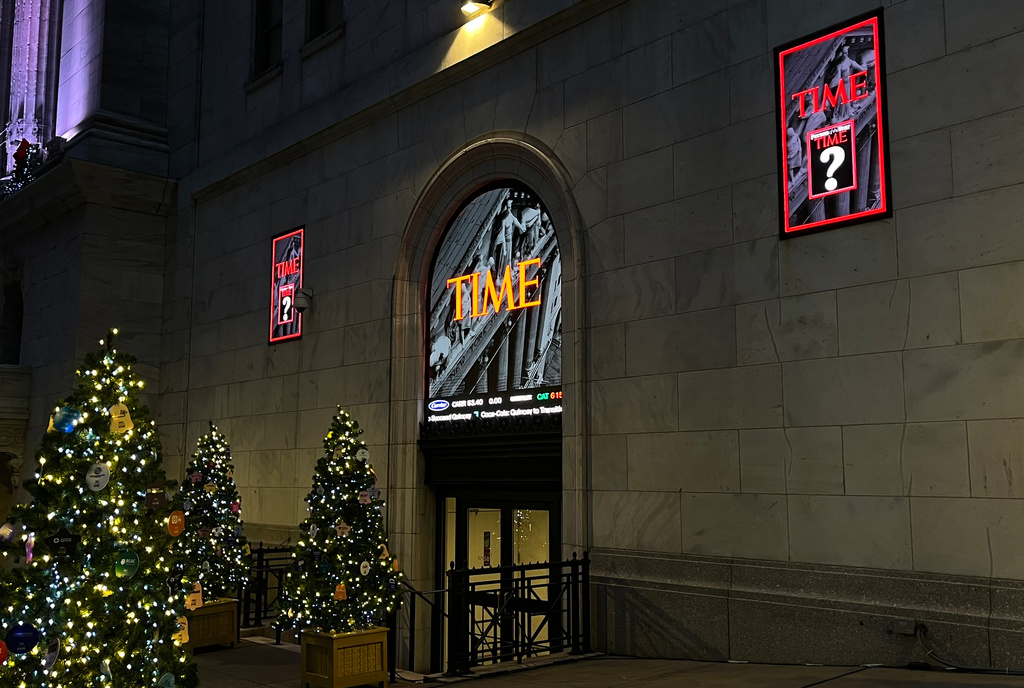 A sign for Time magazine is displayed outside the New York Stock Exchange on Thursday, Dec. 11, 2025 in New York. (AP Photo/Donald King)