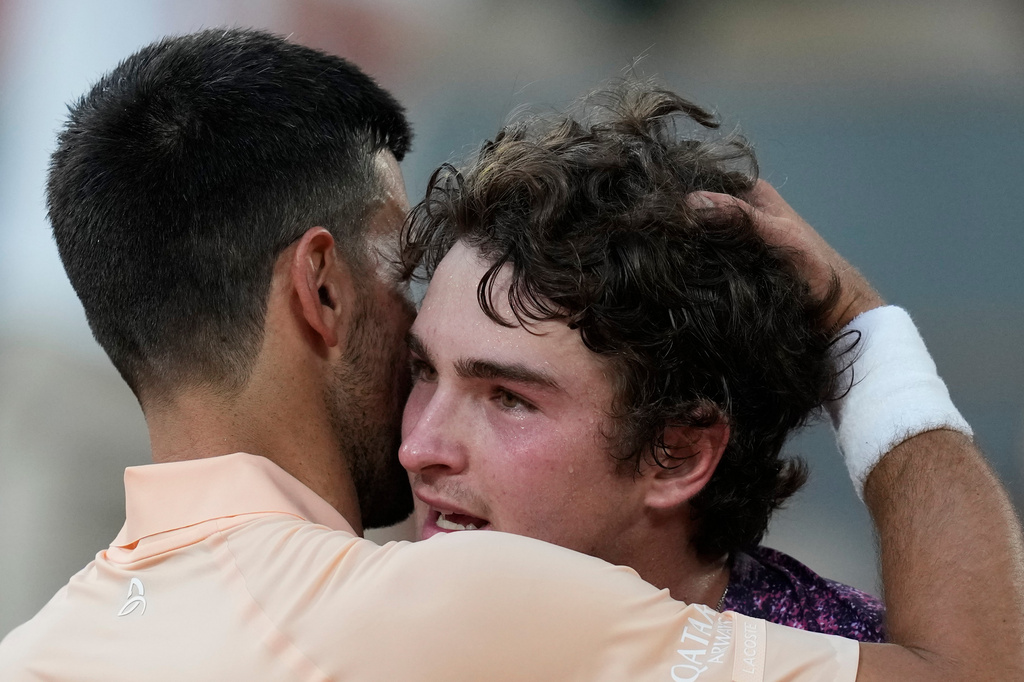 Novak Djokovic of Serbia, left, and Joao Fonseca of Brazil hug after their third round men's singles tennis match at the French Open tennis tournament in Paris, Friday, May 29, 2026. (AP Photo/Christophe Ena)