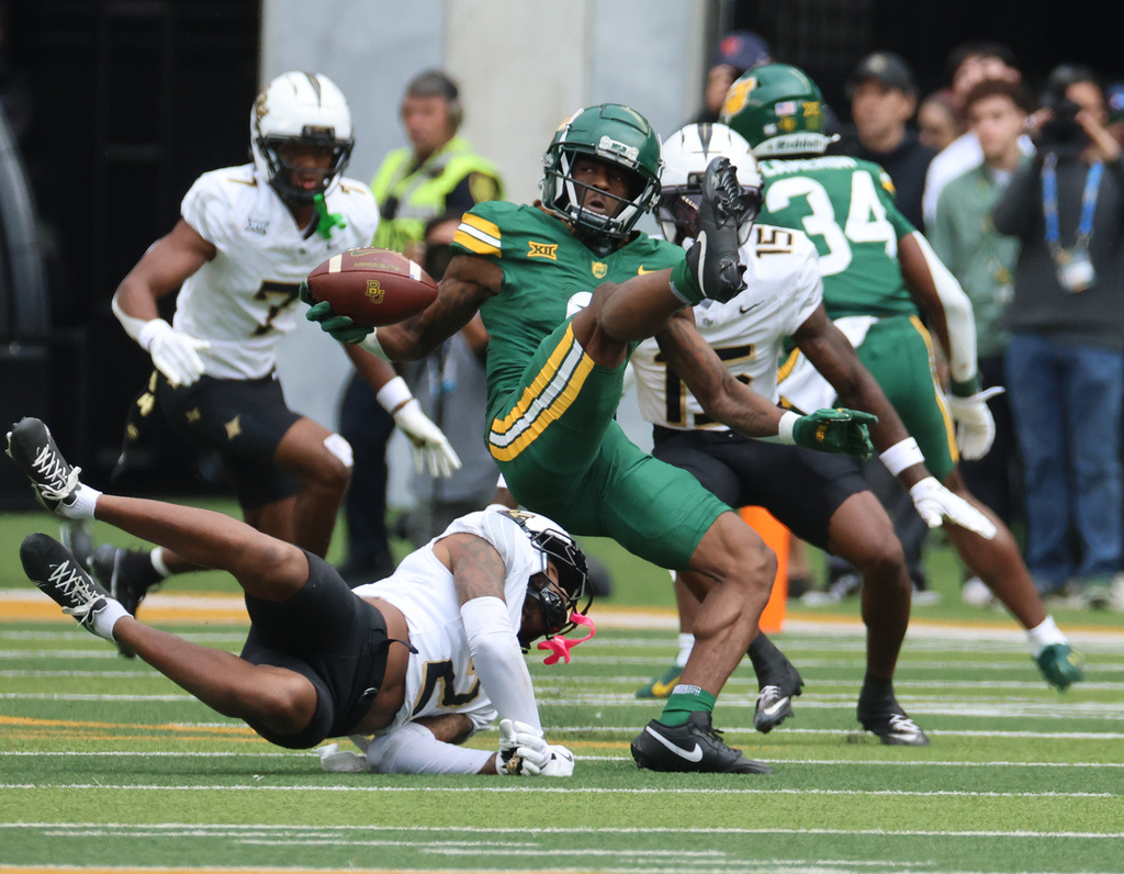 Baylor wide receiver Ashtyn Hawkins pulls in a pass over UCF defensive back Phillip Dunnam during the first half of an NCAA college football game, Saturday, Nov. 1, 2025, in Waco, Texas. (Rod Aydelotte/Waco Tribune-Herald via AP)