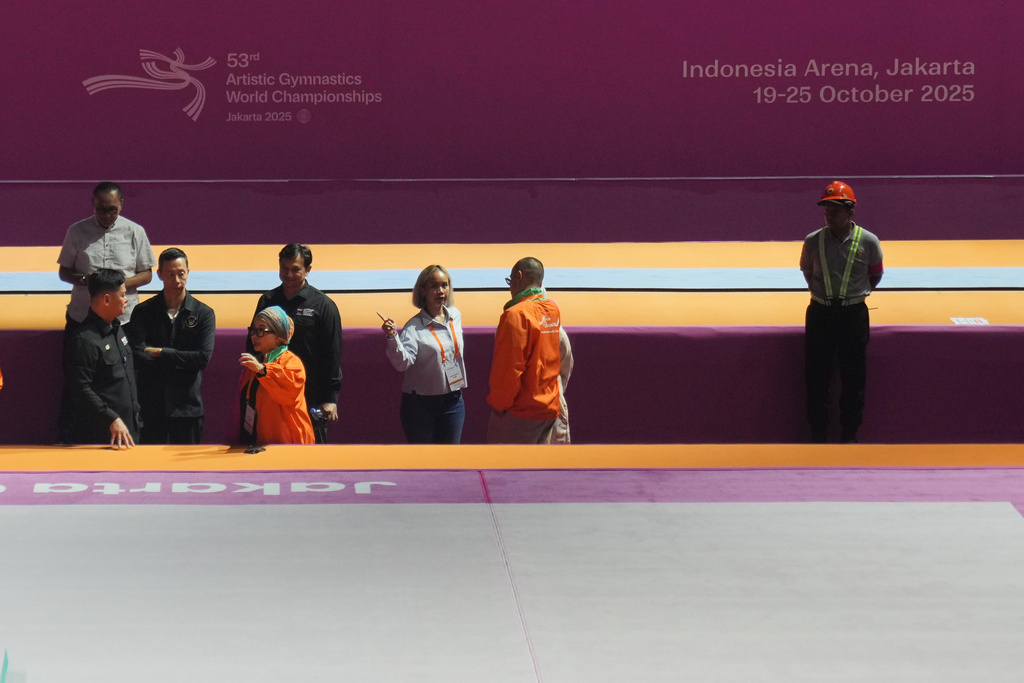 Officials of the Indonesian Gymnastics Federation inspect the venue prepared for the Artistic Gymnastics World Championships at Indonesia Arena in Jakarta, Indonesia, Friday, Oct. 10, 2025. (AP Photo/Dita Alangkara)