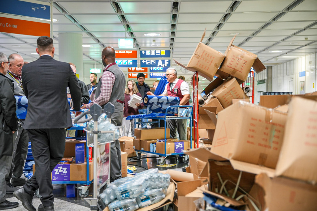 Drinks and snacks are distributed after possible drone sightings closed Munich Airport, Saturday, Oct. 4, 2025, in Munich, Germany. (Enrique Kaczor/onw-images/dpa via AP)