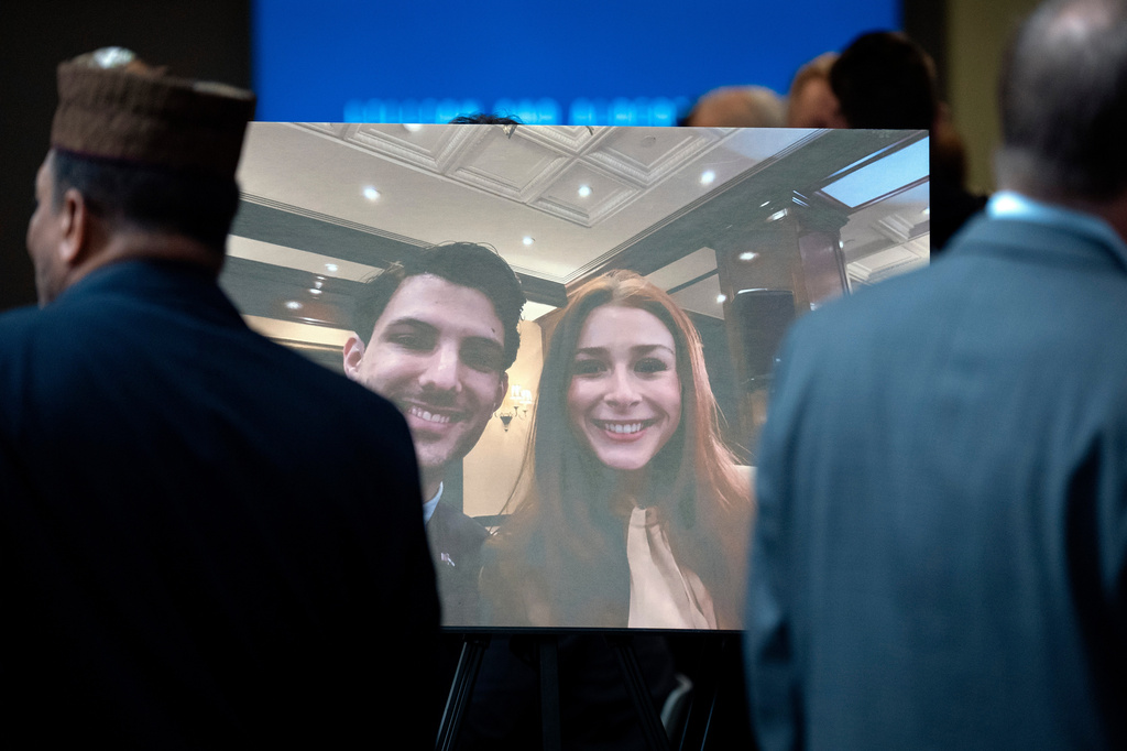 FILE - Visitors walk past a photo of slain Israeli Embassy staff members Yaron Lischinsky, left, and Sarah Milgrim, right, before a service to mark the reopening of the Capital Jewish Museum after the two were killed following an event at the museum, May 29, 2025, in Washington. (AP Photo/Mark Schiefelbein, File)