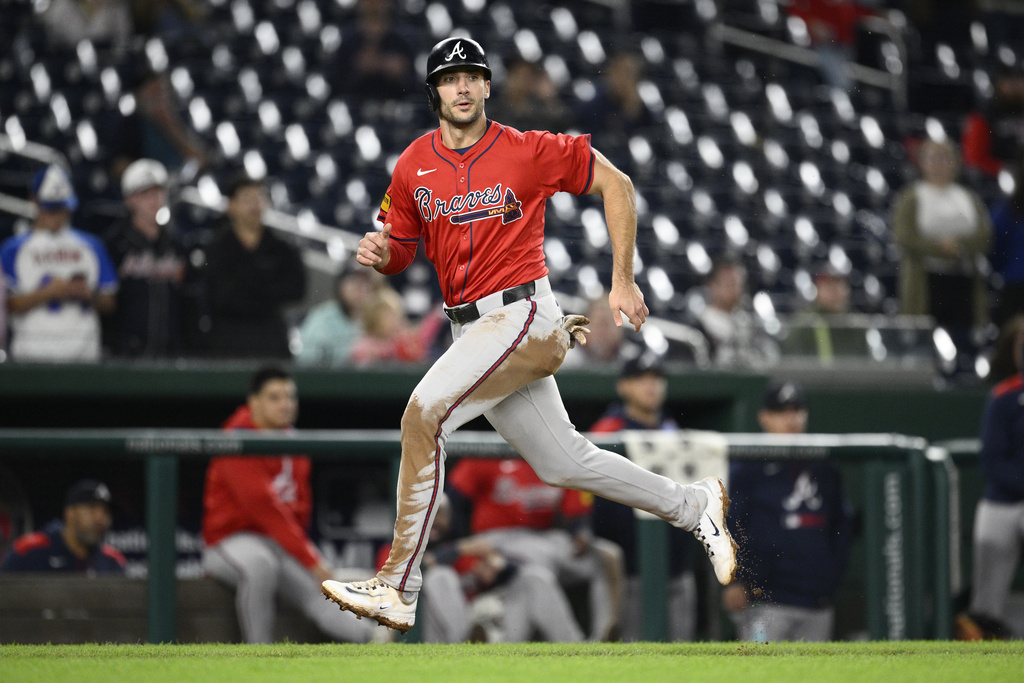 Atlanta Braves' Matt Olson runs towards home to score on a sacrifice fly by Ozzie Albies during the 10th inning of the second baseball game of a doubleheader against the Washington Nationals Tuesday, Sept. 16, 2025, in Washington. (AP Photo/Nick Wass)