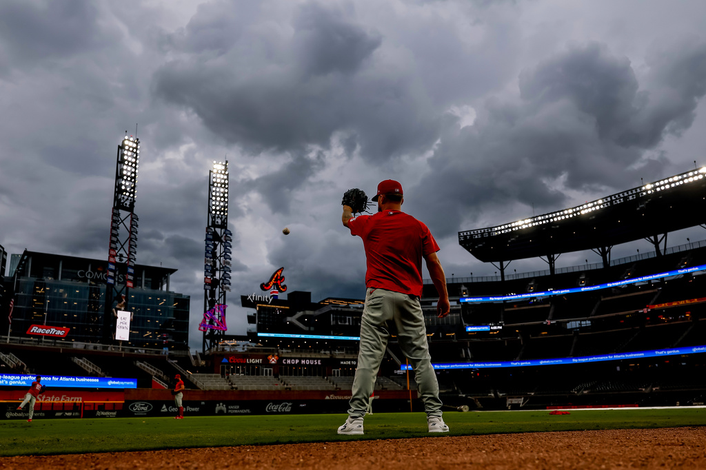 Philadelphia Phillies pitcher Chase Shugart warms up under rain threatening clouds before a baseball game against the Atlanta Braves, Friday, Sept. 11, 2026, in Atlanta. (AP Photo/Erik S. Lesser)