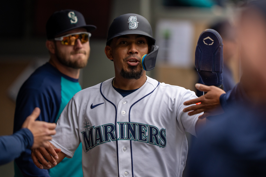 Seattle Mariners' Jhonny Pereda celebrates in the dugout after scoring a run during third inning of a baseball game against the Atlanta Braves, Wednesday, May 6, 2026, in Seattle. (AP Photo/Stephen Brashear)