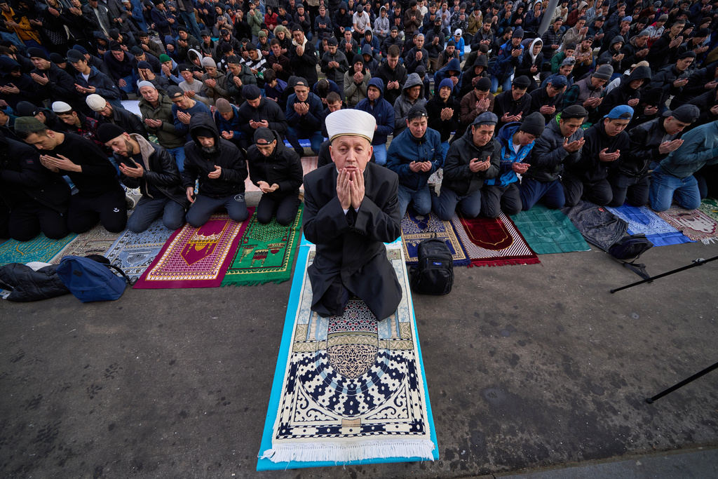Muslims pray outside the Moscow Cathedral Mosque during celebrations of Eid al-Fitr holiday, a feast celebrated by Muslims worldwide, in Moscow, Russia, early Friday, March 20, 2026. (AP Photo/Alexander Zemlianichenko)