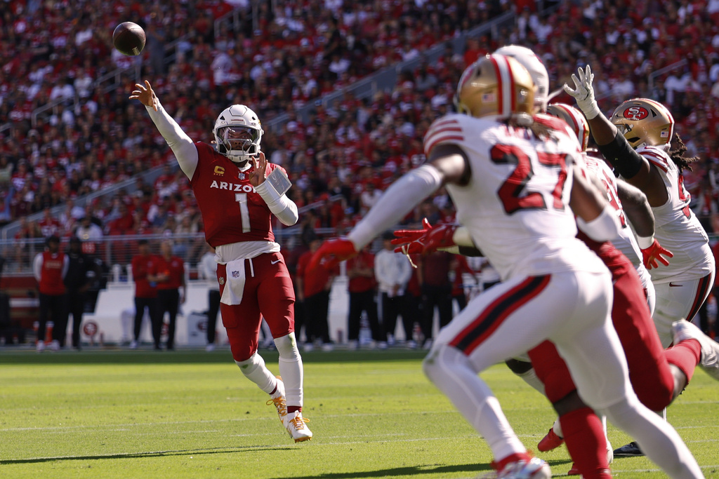 Arizona Cardinals quarterback Kyler Murray, left, throws a touchdown pass during the second half of an NFL football game against the San Francisco 49ers, Sunday, Sept. 21, 2025, in Santa Clara, Calif. (AP Photo/Sergio Estrada)
