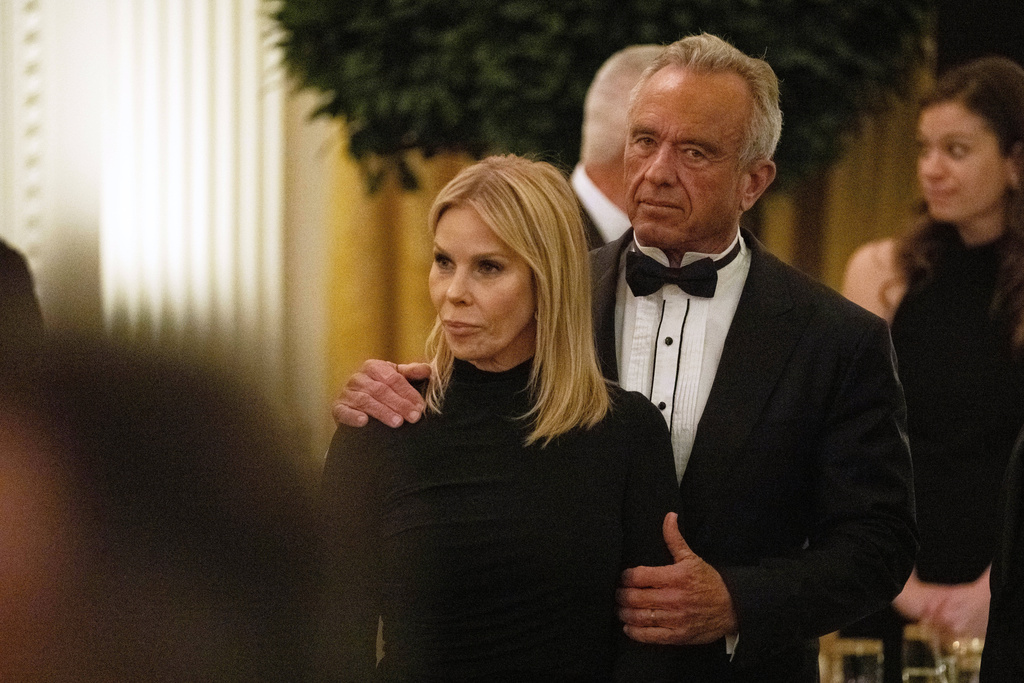 Health and Human Services Secretary Robert F. Kennedy Jr. holds his wife, Cheryl Hines, during the National Governors Association dinner at the White House, Saturday, Feb. 21, 2026, in Washington. (AP Photo/Allison Robbert)