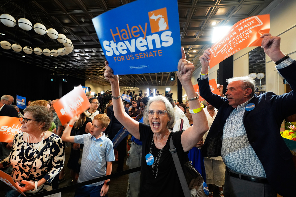 Attendees hold signs for Rep. Haley Stevens, D-Mich., a candidate in the Democratic primary for U.S. Senate in Michigan, during a primary election night event Tuesday, Aug. 4, 2026, in Detroit. (AP Photo/Paul Sancya)