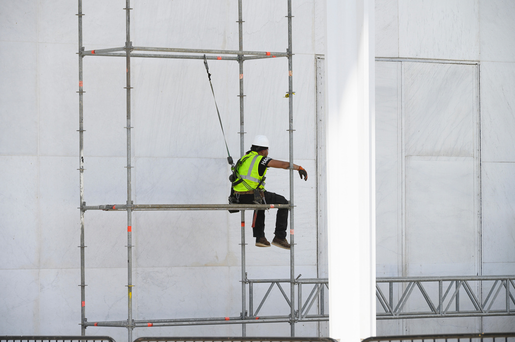 A worker sits on scaffolding at the John F. Kennedy Center for the Performing Arts in Washington, Friday, June 12, 2026. (AP Photo/Cliff Owen)