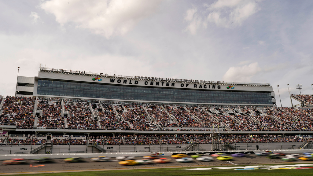 FILE - Cars move during the NASCAR Daytona 500 auto race at Daytona International Speedway, Feb. 15, 2026, in Daytona Beach, Fla. (AP Photo/Nigel Cook, File)