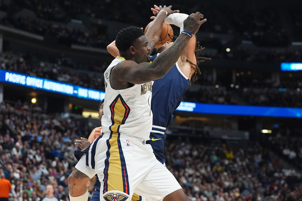 New Orleans Pelicans forward Zion Williamson, front, blocks a shot by Denver Nuggets forward Aaron Gordon in the first half of an NBA basketball game Wednesday, Oct. 29, 2025, in Denver. (AP Photo/David Zalubowski)