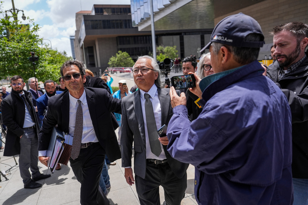 Kenneth Iwamasa, center, one of five people who pleaded guilty in connection with the ketamine overdose death of actor Matthew Perry, and his attorney, Alan Eisner, left, leave federal court after Iwamasa's sentencing in Los Angeles, Wednesday, May 27, 2026. (AP Photo/Jae C. Hong)