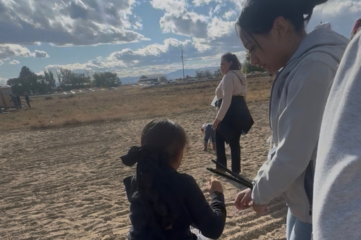 This photo provided by Anabel Romero shows her 14-year-old daughter, right, with her hands zip-tied, next to her 8-year-old daughter, foreground center, during a raid by various law enforcement agencies at La Catedral Arena horse race track in Wilder, Idaho, on Oct. 19, 2025. (Anabel Romero via AP) This photo provided by Anabel Romero shows her 14-year-old daughter, right, with her hands zip-tied, next to her 8-year-old daughter, foreground center, during a raid by various law enforcement agencies at La Catedral Arena horse race track in Wilder, Idaho, on Oct. 19, 2025. (Anabel Romero via AP)
