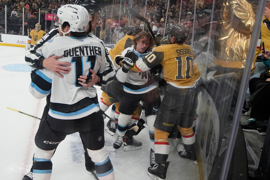 Vegas Golden Knights and Utah Mammoth players fight during the first period of Game 5 of a first-round NHL hockey Stanley Cup playoff series Wednesday, April 29, 2026, in Las Vegas. (AP Photo/John Locher)