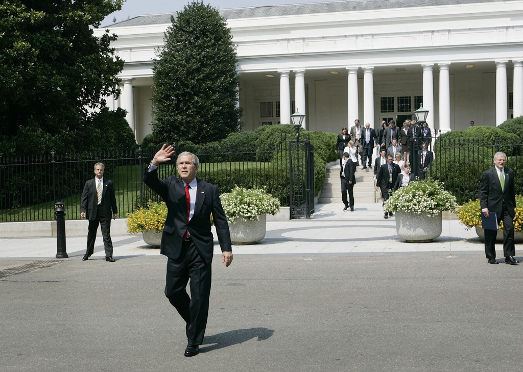 FILE - President Bush waves as walks away from the East Wing of the White House to the neighboring Treasury Building for the swearing-in of Treasury Secretary Henry Paulson, July 10, 2006 in Washington. At right is Chief of Staff Joshua Bolton. (AP Photo/Pablo Martinez Monsivais, File)