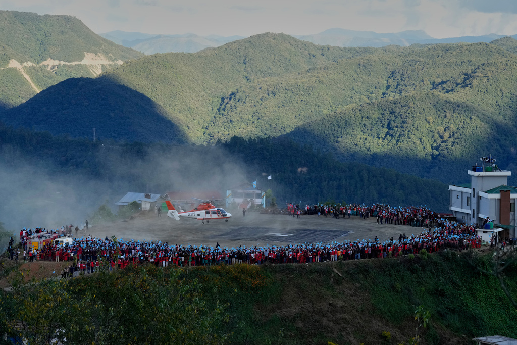 A chopper lands carrying Thuingaleng Muivah, leader of the National Socialist Council of Nagaland (Isak-Muivah), in his native Somdal village, in the northeastern Indian state of Manipur, Wednesday, Oct. 22, 2025. (AP Photo/Anupam Nath)