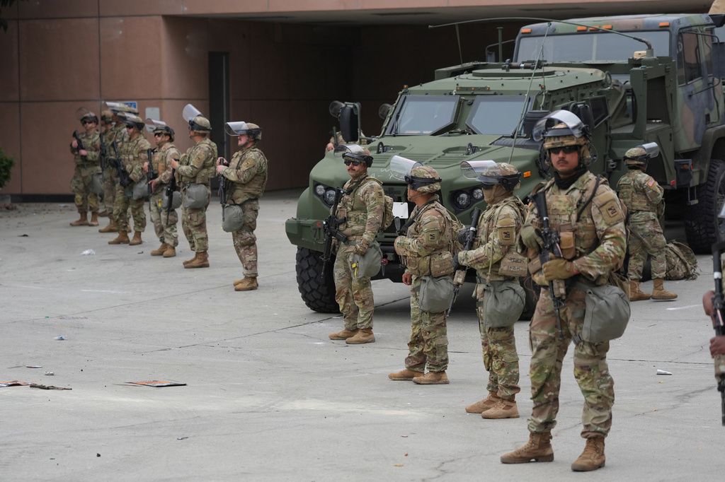 FILE - U.S. National Guard are deployed outside the federal prison in downtown Los Angeles, Sunday, June 8, 2025, following a immigration raid protest the night before. (AP Photo/Jae Hong, File)