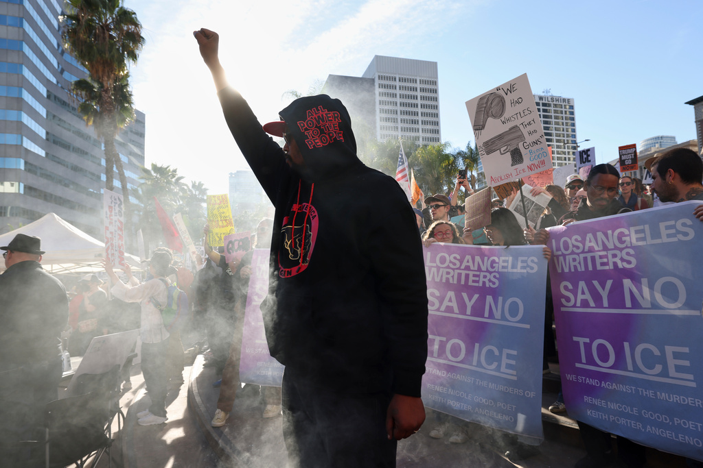 A protester gestures during a demonstration calling for an end to federal immigration enforcement operations and U.S. attacks on Venezuela, Saturday, Jan. 10, 2026, in Los Angeles. (AP Photo/Jill Connelly)