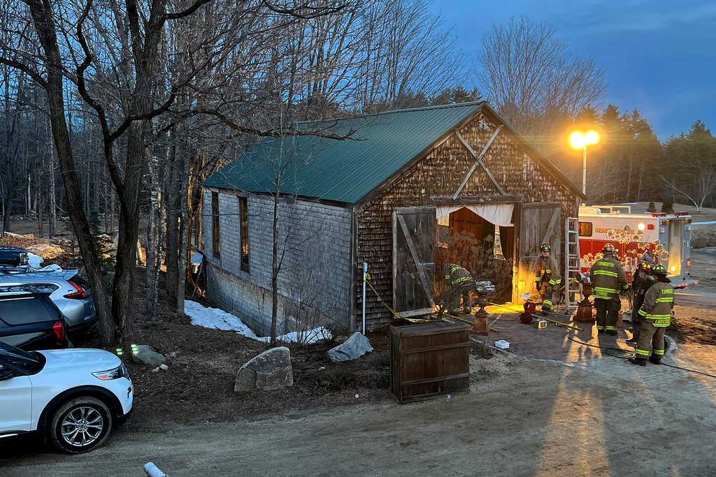 Firefighters work at a building in Tamworth, New Hampshire, where the floor collapsed during a wedding Saturday, March 21, 2026. State Fire Marshal's Office investigators believe a building was overcrowded prior to the collapse that sent six people to the hospital. (New Hampshire State Fire Marshal's Office via AP)