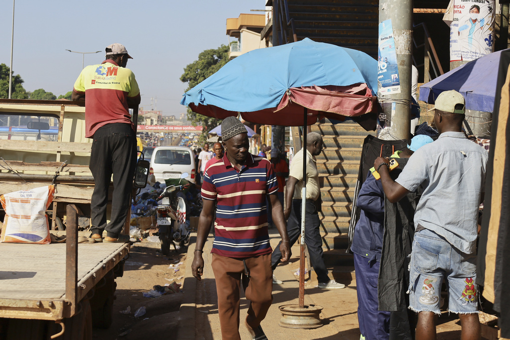 People shop at a market in Bissau, Guinea-Bissau, Friday, Nov. 28, 2025. (AP Photo/Darcicio Barbosa)