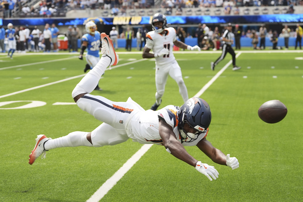 Denver Broncos wide receiver Marvin Mims Jr. (19) misses on a catch attempt during the first half an NFL football game against the Los Angeles Chargers, Sunday, Sept. 21, 2025, in Inglewood, Calif. (AP Photo/Gregory Bull)