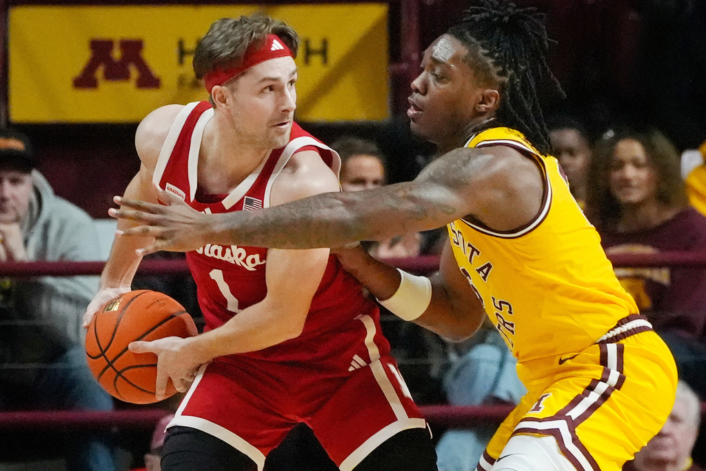 Minnesota guard Langston Reynolds, right, guards against Nebraska guard Sam Hoiberg (1) in the first half of an NCAA basketball game Saturday, Jan. 24, 2026, in Minneapolis. (AP Photo/Bruce Kluckhohn)