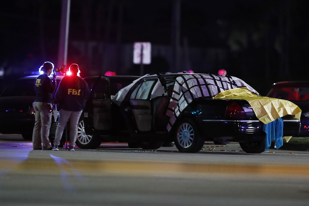 FILE - Authorities investigate the scene of a fatal shooting Dec. 5, 2019, in Miramar, Fla. (AP Photo/Brynn Anderson, File)