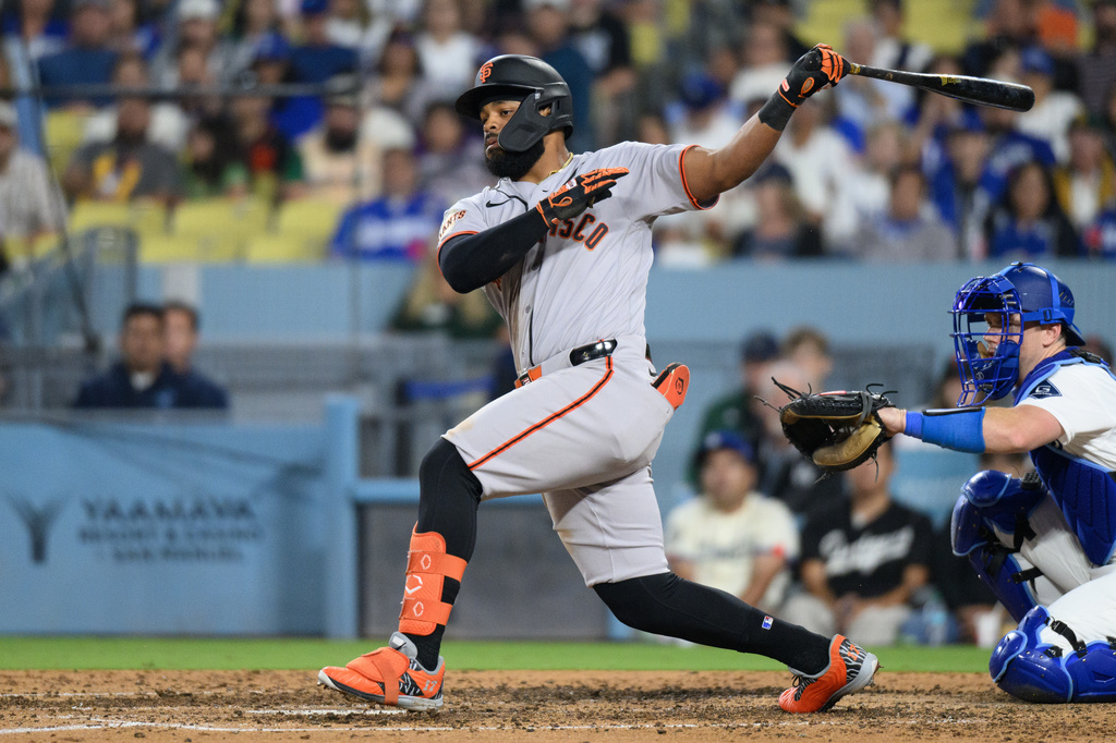 San Francisco Giants' Heliot Ramos hits a two-run double during the sixth inning of a baseball game against the Los Angeles Dodgers in Los Angeles, Monday, May 11, 2026. (AP Photo/Kyusung Gong)