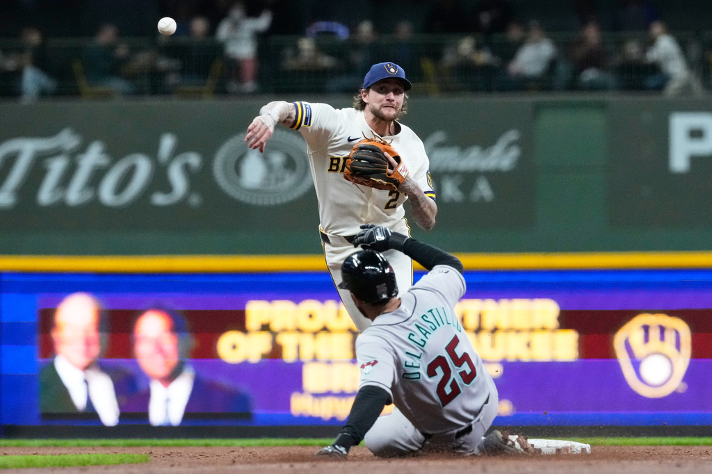 Milwaukee Brewers second baseman Brice Turang, top, throws out Arizona Diamondbacks' Nolan Arenado at first after forcing out Adrian del Castillo during the second inning of a baseball game Tuesday, April 28, 2026, in Milwaukee. (AP Photo/Nam Y. Huh)