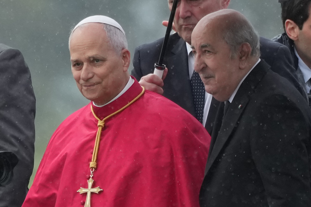 Pope Leo XIV is welcomed by Algerian President Abdelmadjid Tebboune, right, upon his arrival at Algiers' Houari Boumédiène International Airport on Monday, April 13, 2026, at the start of an 11-day apostolic journey to Africa. (AP Photo/Andrew Medichini)