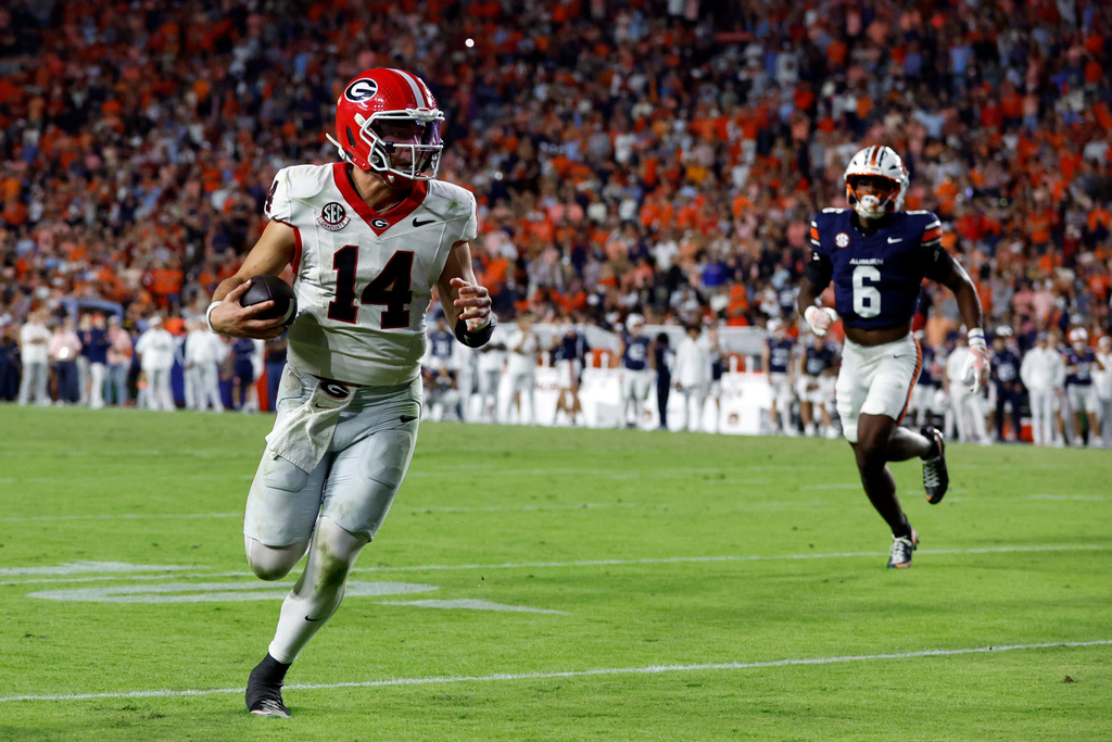 Georgia quarterback Gunner Stockton (14) carries the ball for a touchdown against Auburn during the second half of an NCAA college football game, Saturday, Oct. 11, 2025, in Auburn, Ala. (AP Photo/Butch Dill)