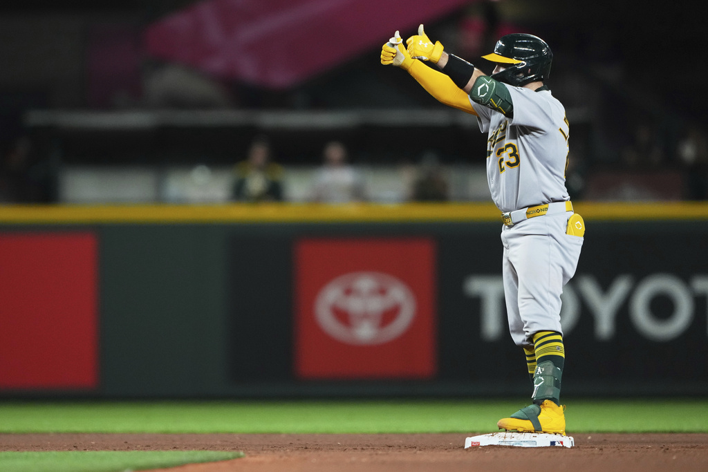 Athletics' Shea Langeliers celebrates his RBI double against the Seattle Mariners during the 10th inning of a baseball game Saturday, Aug. 23, 2025, in Seattle. (AP Photo/Lindsey Wasson)