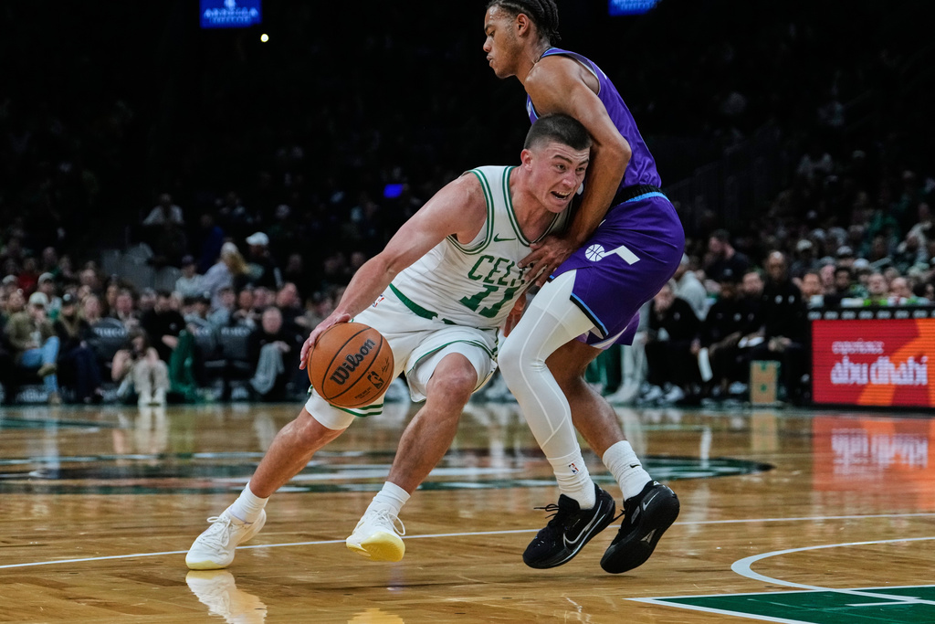 Boston Celtics guard Payton Pritchard (11) drives to the basket against Utah Jazz guard Keyonte George (3) during first half of an NBA basketball game, Monday, Nov. 3, 2025, in Boston. (AP Photo/Charles Krupa)
