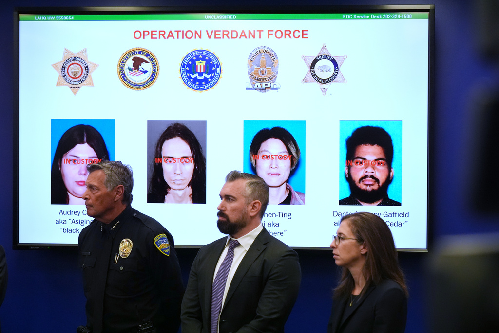 Photos of suspects of a terror plot are shown on a screen during a press conference Monday, Dec. 15, 2025, in Los Angeles. (AP Photo/Damian Dovarganes)