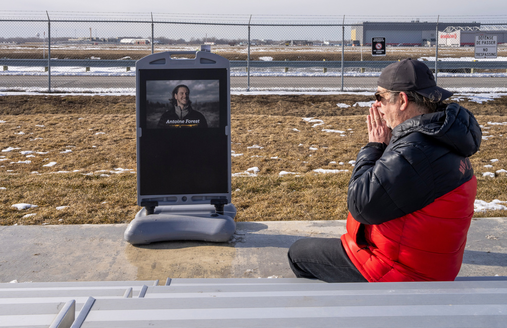 Airplane enthusiast Jean-Francois Lamarche visits a memorial for Air Canada Jazz pilot Antoine Forest, who perished when his plane collided with an emergency vehicle at New York's LaGuardia Airport, in Montreal, Wednesday, March 25, 2026. (Christinne Muschi/The Canadian Press via AP)