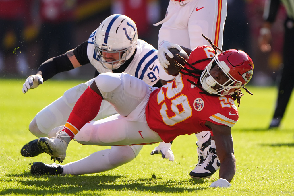 Indianapolis Colts defensive end Laiatu Latu (97) tackles Kansas City Chiefs running back Kareem Hunt (29) during the first half of an NFL football game Sunday, Nov. 23, 2025, in Kansas City, Mo. (AP Photo/Charlie Riedel)